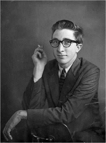 Historical black-and-white portrait of writer John Updike wearing eyeglasses
